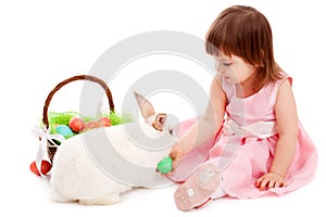Little girl playing with fur eatser rabbit