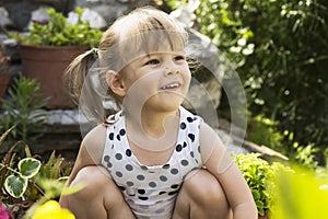 Little girl playing in garden