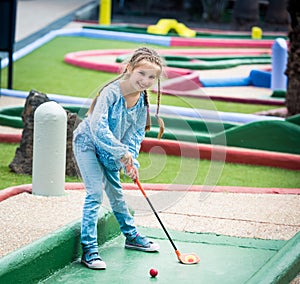 Little girl playing golf