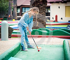 Little girl playing golf