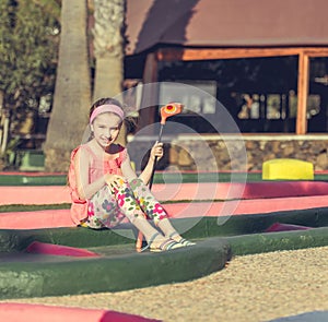 Little girl playing golf