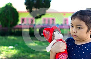 Little girl playing with her baby doll.