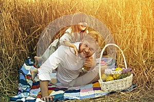 A little girl is playing with her dad