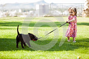 Little girl playing with her dog