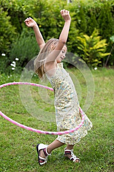 Little girl playing with hula hoop