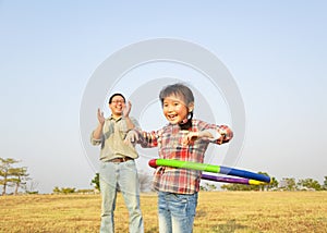 little girl playing with hula hoops outdoors photo