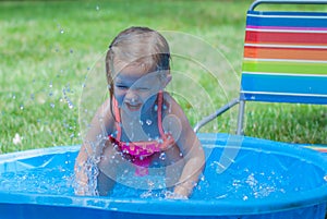 Little Girl Playing in a Kiddie Pool