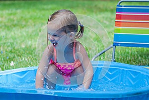 Little Girl Playing in a Kiddie Pool