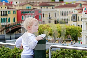 Little girl playing in miniature park