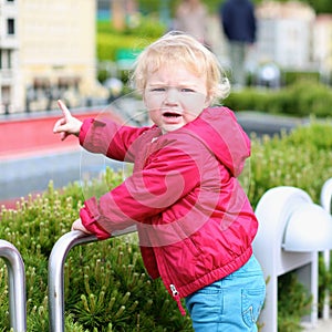 Little girl playing in miniature park