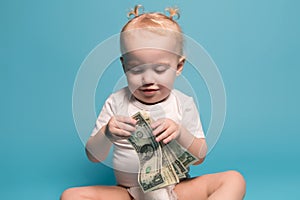 Little girl is playing with money