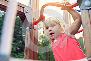 Little girl playing on monkey bars, kids sport