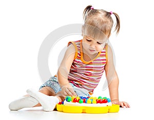 Little girl playing with mosaic toy