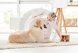 Little girl playing music with dog