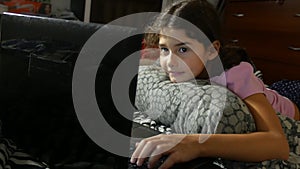 Little girl playing in the notebook child online game laptop