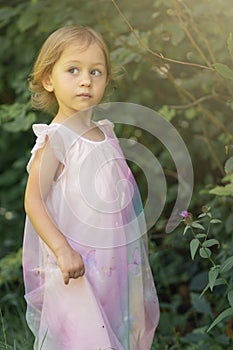 Little girl playing outdoor in nature inside a forest. Education in nature