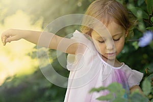 Little girl playing outdoor in nature inside a forest. Education in nature