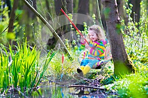 Little girl playing outdoors fishing