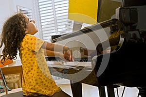 Little girl playing the piano photo