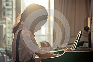 Little girl playing with piano and Music Tablet at home