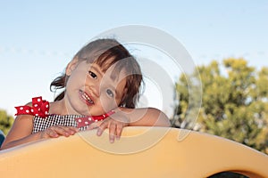 Little Girl Playing on Playground Equipment