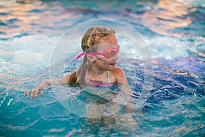 Little girl playing on the pool