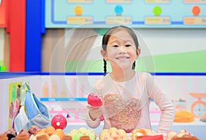 Little girl playing pretend as a sale in ice-cream shop