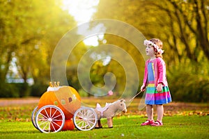 Little girl playing princess at pumpkin patch