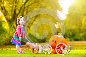 Little girl playing princess at pumpkin patch