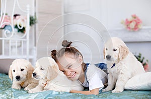 Little girl playing with Puppies Retriever