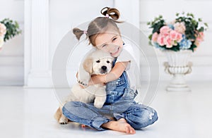 Little girl playing with Puppies Retriever