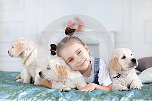 Little girl playing with Puppies Retriever