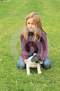 Little girl playing with a puppy