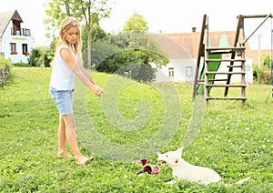 Little girl playing a puppy