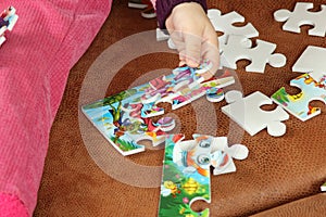 Little Girl Playing With Puzzle Pieces