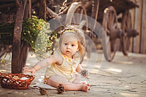 Little girl playing with rabbit in the village. Outdoor. Summer portrait.