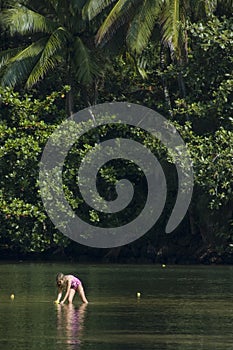 Little girl playing in the river.