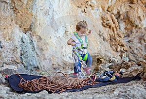 Little girl playing with rock climbing equipment