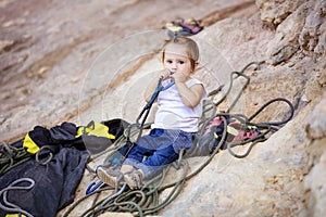 Little girl playing with rock climbing gear