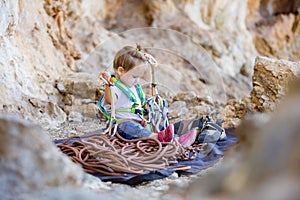 Little girl playing with rock climbing gear