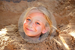 Little girl playing in sand