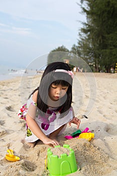Little girl playing sand