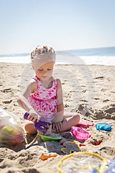 Little Girl Playing With Sand Toys at the Beach