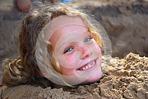 Little girl playing in sandpit