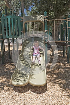 Little Girl Playing on a Slide photo