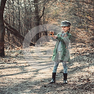 Little girl playing with a slingshot