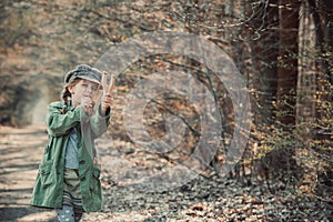 Little girl playing with a slingshot