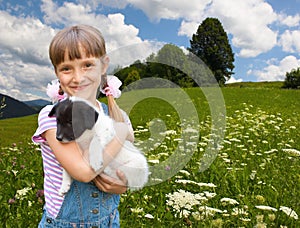 Little girl playing with small puppiy