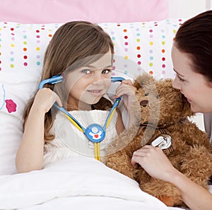 Little girl playing with a stethoscope