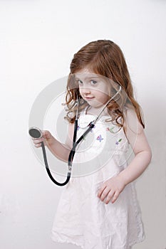 Little girl playing with stethoscope